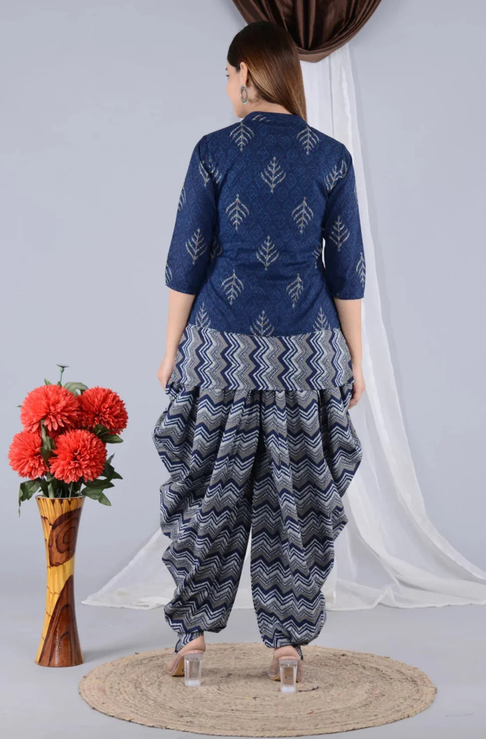 Woman wearing blue printed maternity kurta with zigzag patterned harem pants, back view