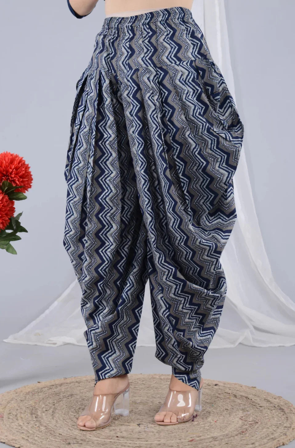 Woman wearing navy blue and grey zigzag printed dhoti pants, styled for maternity comfort